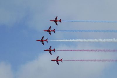 Low angle view of helicopter flying in sky