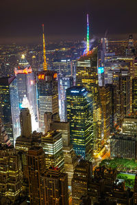 High angle view of illuminated buildings in city at night