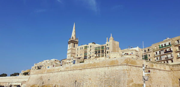 Low angle view of historical building against blue sky