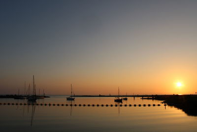Scenic view of sea against clear sky during sunset