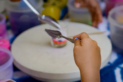 Close-up of hand holding spoon