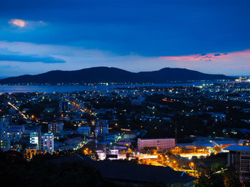 High angle view of illuminated city against sky at night