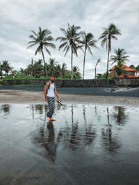 Full length of man standing on beach