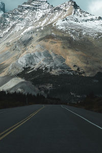 Road leading towards snowcapped mountain