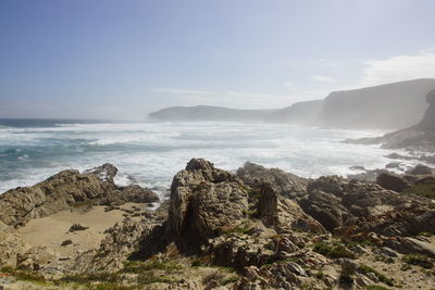 View of rocky beach against the sky