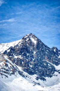 Scenic view of snowcapped mountain against blue sky