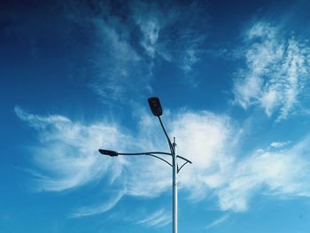 Low angle view of street light against blue sky