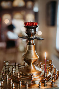 Close-up of lit candles on table