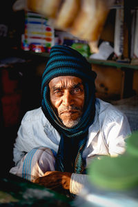 Portrait of man wearing hat sitting at home