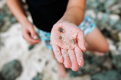 Midsection of woman holding sand