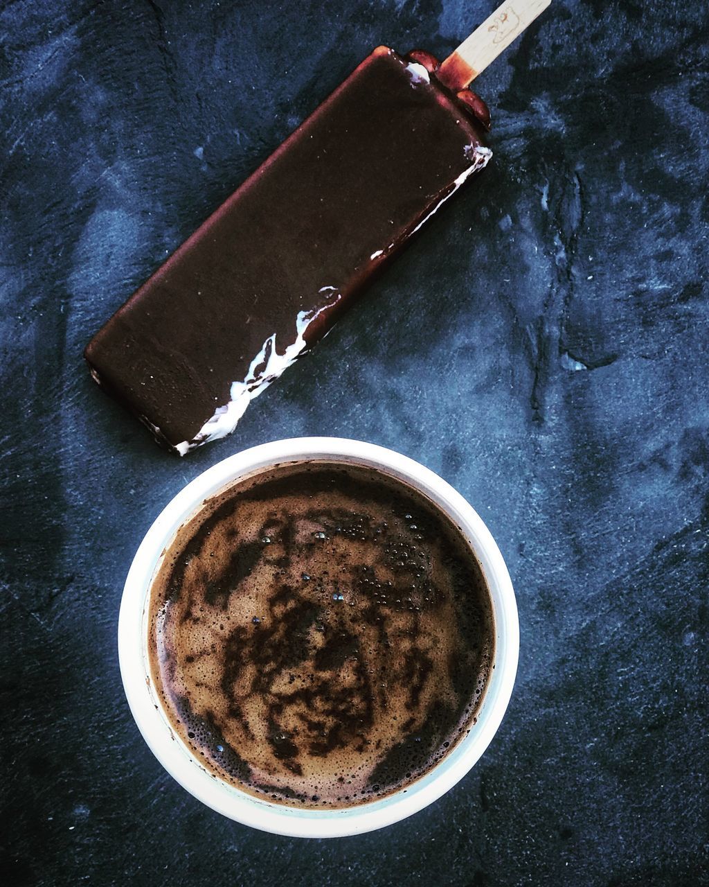 HIGH ANGLE VIEW OF COFFEE CUP WITH SPOON AND DRINK