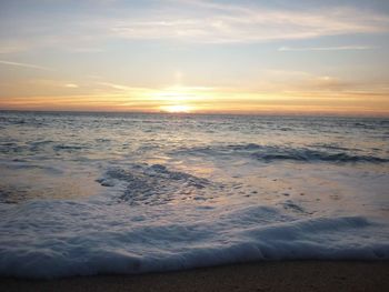 Scenic view of beach against sky during sunset