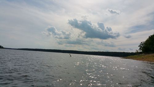 Scenic view of calm sea against cloudy sky