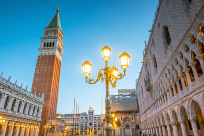 Low angle view of illuminated buildings against sky