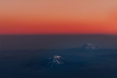 Scenic view of snowcapped mountains against sky during sunset
