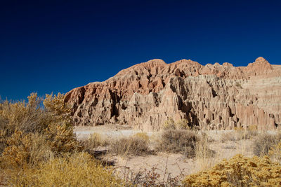 Scenic view of mountains against clear blue sky