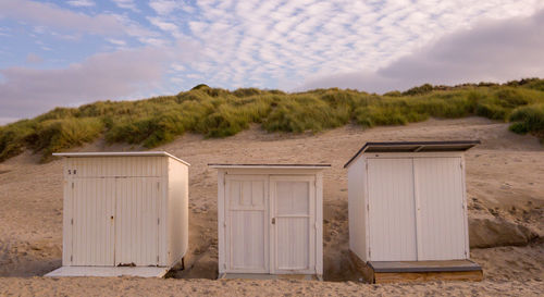 Built structure on beach against sky