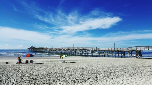 Scenic view of beach against blue sky