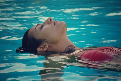 Woman relaxing in swimming pool