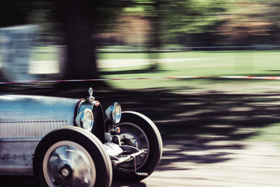 Vintage car moving on road at park