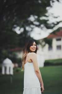 Portrait of a smiling young woman standing outdoors