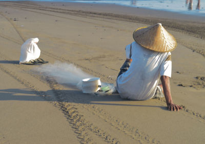 People sitting on sand at beach