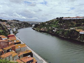 High angle view of townscape by sea against sky