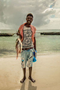 Portrait of teenage girl standing on beach