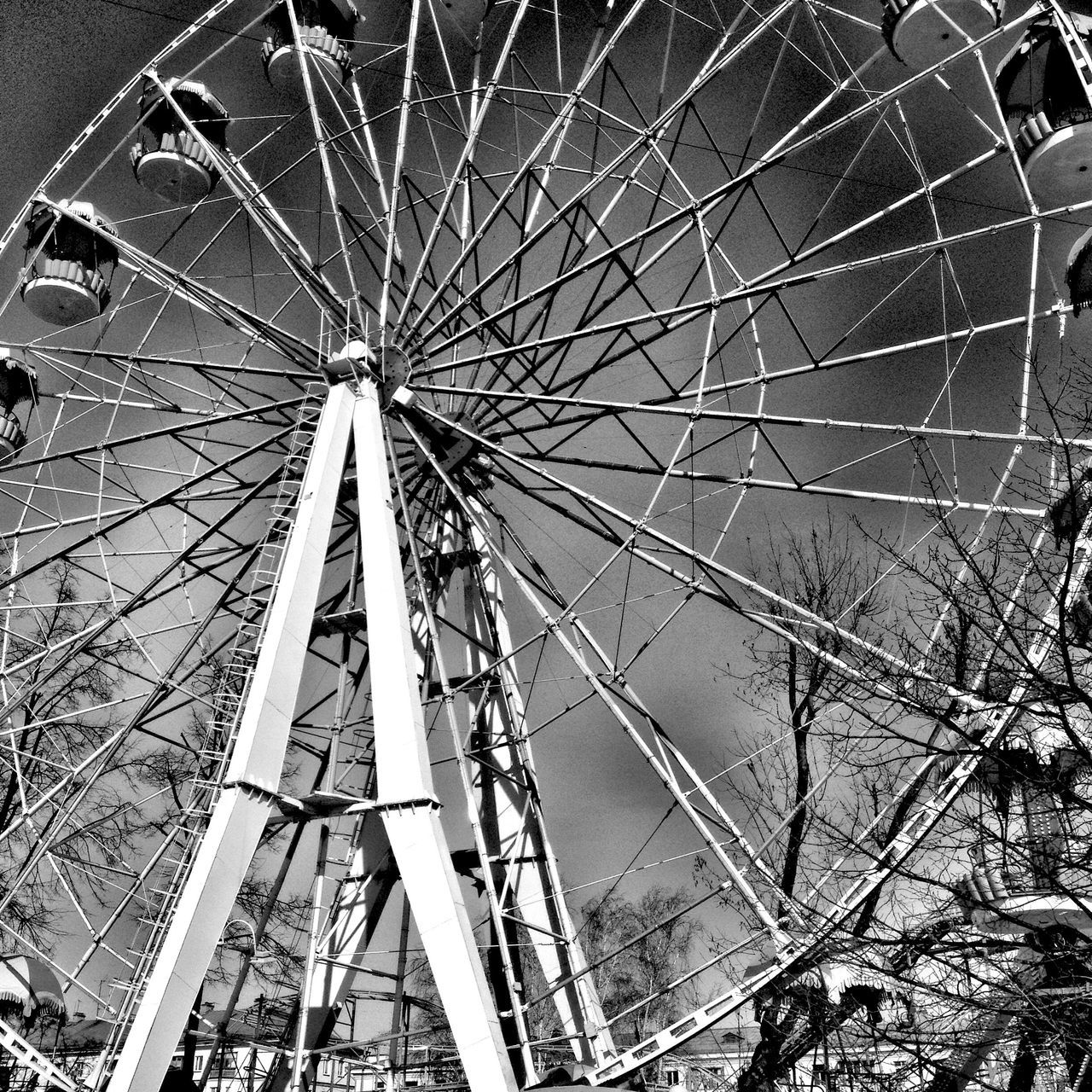 amusement park, arts culture and entertainment, ferris wheel, amusement park ride, big wheel, low angle view, no people, day, outdoors, leisure activity, spoke, sky