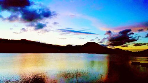 Scenic view of lake against romantic sky at sunset