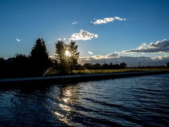 Scenic view of lake against sky at sunset