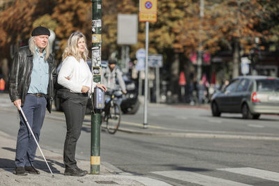 Senior couple standing at zebra crossing