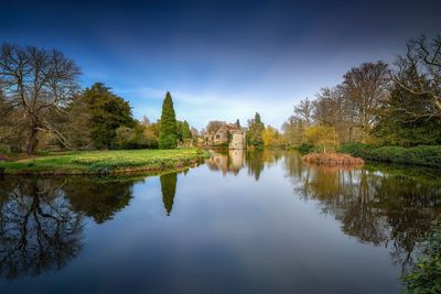 Reflection of trees in lake against sky