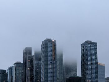 Low angle view of modern buildings against clear sky