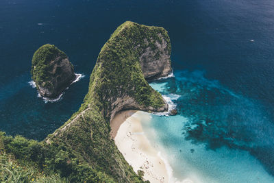 High angle view of rock in sea against sky