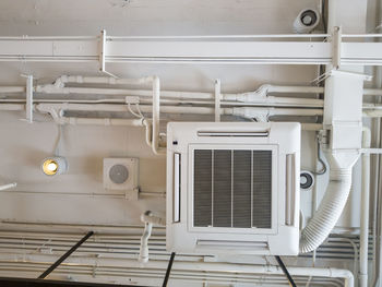 Low angle view of electric fan on wall