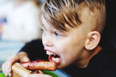 Close-up portrait of boy eating food