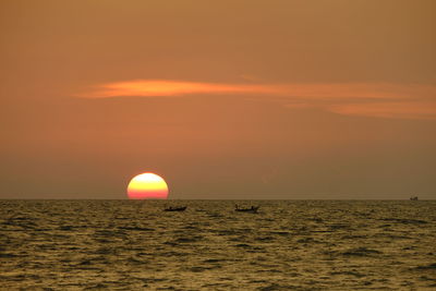 Scenic view of sea against romantic sky at sunset