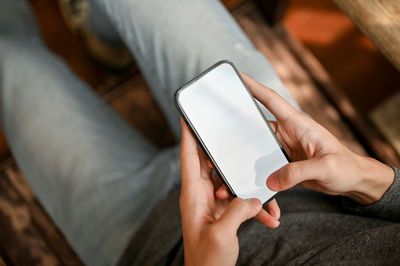 Midsection of man using mobile phone