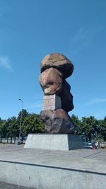 Low angle view of statue against blue sky