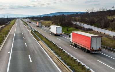 Vehicles on road against sky