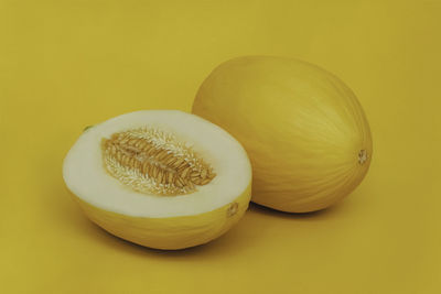 Close-up of yellow fruit over white background