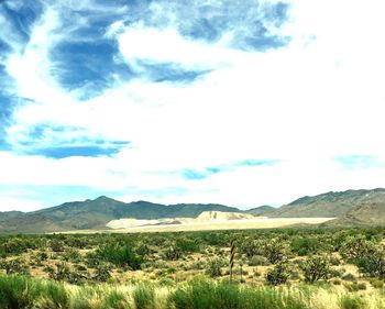 Scenic view of landscape against cloudy sky