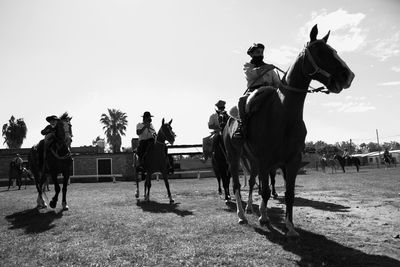 People riding horses in south american ranch