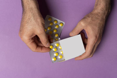 Cropped hand of woman holding pills