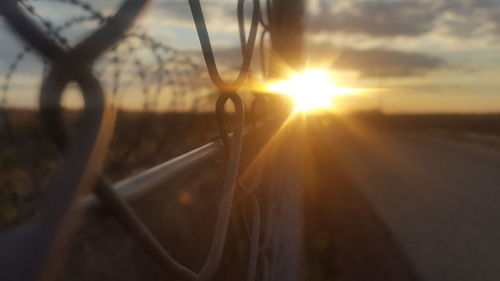 Close-up of car against sky during sunset