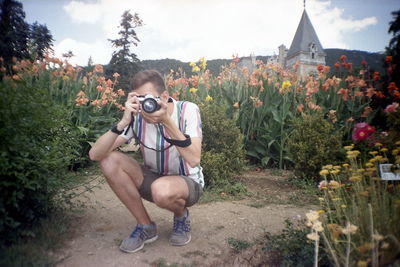 Portrait of man sitting on plant