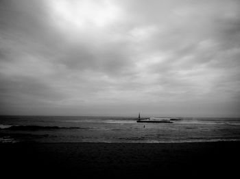 Scenic view of sea against cloudy sky