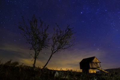 Built structure on field against sky at night