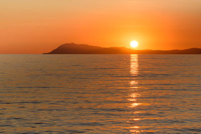 Scenic view of sea against orange sky